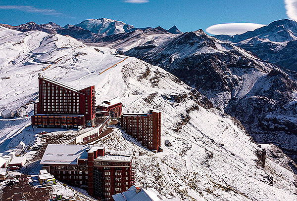 Turistas observam o imenso cenário dos Andes cobertos de neve em um mirante de tirar o fôlego